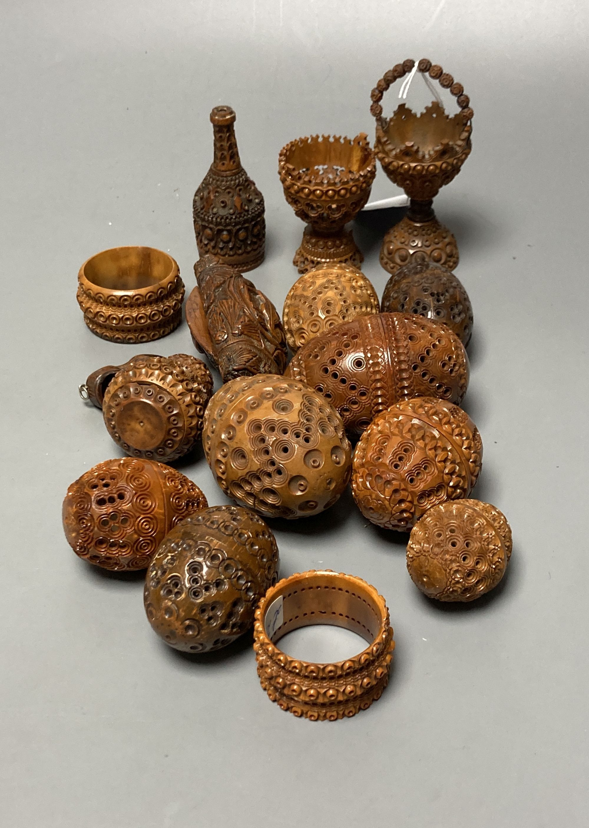 A quantity of coquilla nut carvings